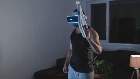 Man Puts Virtual Reality Googles on Head and Raises Gun, Ready for Battle Stock Footage 108882009