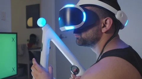 Man Puts Virtual Reality Googles on Head and Raises Gun for Battle, Green Screen Stock Footage 108882386