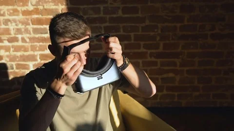 Man Puts on Virtual Reality Helm Stock Footage
