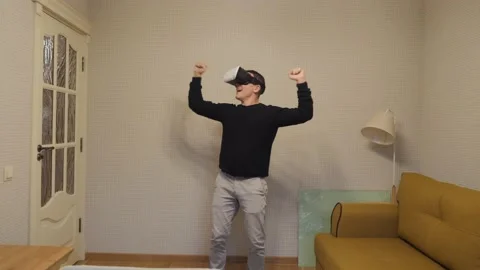 The man puts on VR glasses and is amazed. Stock Footage 143900215