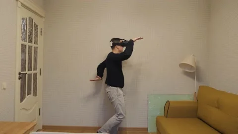 The man puts on VR glasses and is amazed. Stock Footage 143948527