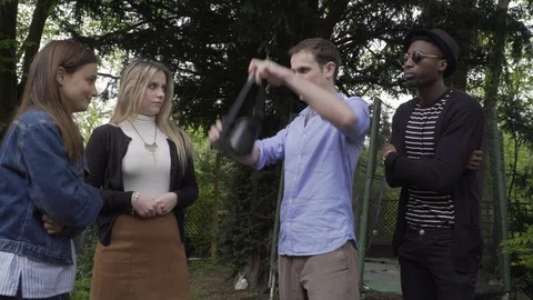 Man puts on VR headset in front or friends scared Stock Footage 89922204