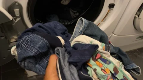 Man puts washing machine subjective point of view of clothes i washing machine Stock Footage 228294463
