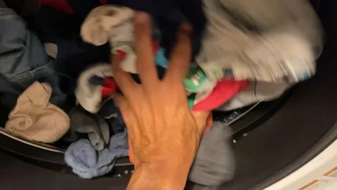 Man puts washing machine subjective point of view of clothes i washing machine 動画素材 228294492