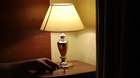 A man puts a watch on the bedside table Stock Footage 312289322