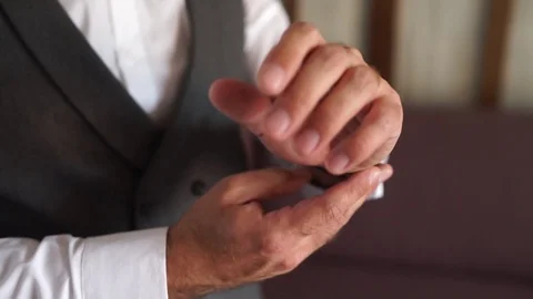 Man puts a watch on his hand Stock Footage 125334036
