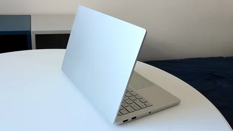 Man puts web camera on laptop Stock Footage 86414486