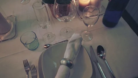 Man puts wine glass on dinner table Stock Footage 73898034