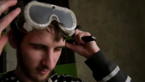 Man puts on work glasses and eats chocolate Stock Footage 77413056