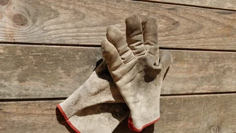 A man puts on work gloves 스톡 동영상 124863938