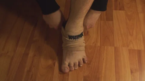 Man Putting Ankle Guard, Ankle Pain, Injury, Accident Front-Shot Stock Footage 36560984