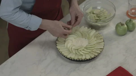 Man Putting Apple Cut Slices on Plate for Cook Pie Video stock 164019920