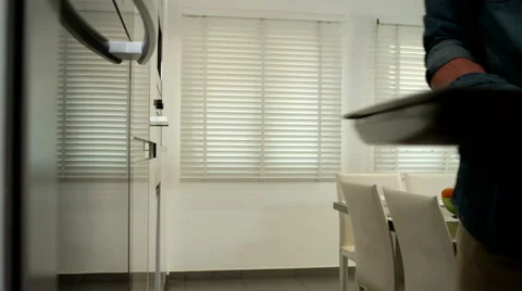 Man putting baking tray into oven. Stock Footage 64107093