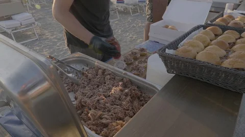 Man putting BBQ Sauce on pulled pork sandwiches Stock Footage 93440649