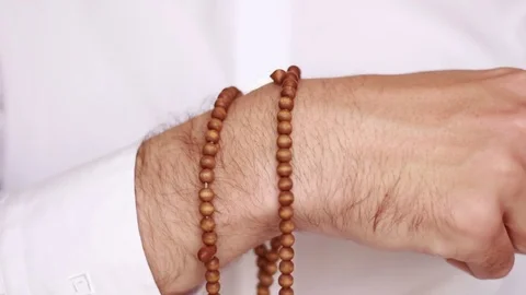 Man putting beads on his wrist Stock Footage 75048840