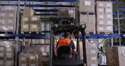 Man Putting Boxes On Shelf While Driving Forklift Stock Footage 142893925