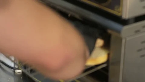 Man Putting Bread Roll Halves Into a Grill Stock Footage 71553146