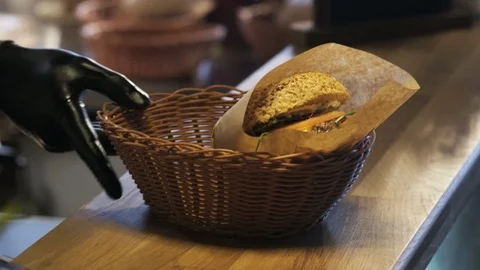 Man Putting a Burger Into a Basket Stock Footage 71558078