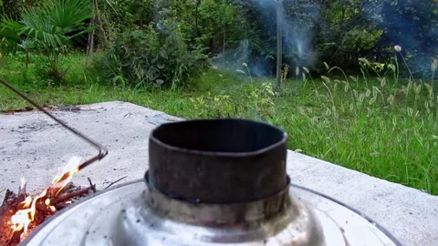 Man putting burning coals in to Russian traditional samovar to make a tea Video stock 139795754