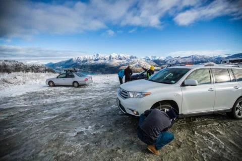 Man putting on Chains Stock Photos