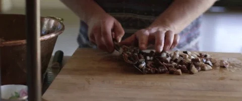 Man putting chopped tentacles of octopus into a utensil Stock Footage 69200723
