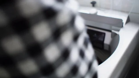 Man putting clothes in washing machine - POV Stock Footage 83133315