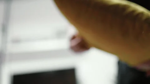 Man putting cotton bedding into under the couch storage place. Small space conce Stock Footage 319334635