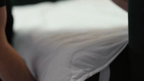 Man putting cotton bedding into under the couch storage place. Stock Footage 319334752