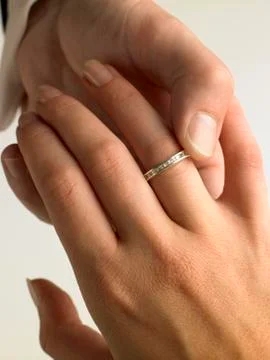 Man Putting Diamond Ring On Woman's Finger Stock Photos