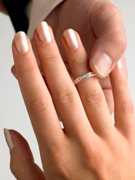 Man Putting Diamond Ring On Woman's Finger Stock Photos