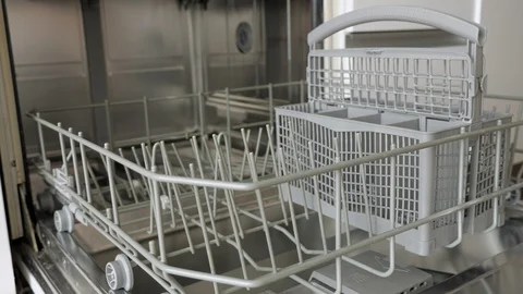 Man is putting dirty tableware in dishwasher, hands closeup. Stock Footage 111505981
