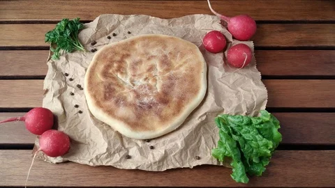 Man putting down khachapuri on table Stock Footage 106934720