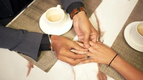 Man Putting Engagement Ring on Woman's Finger Stock Footage 341846160