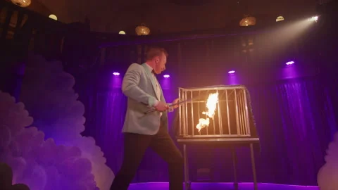 Man putting fire in the cage Stock Footage 270482723