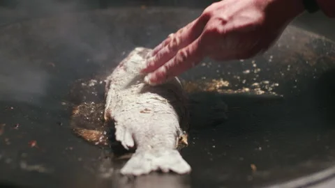 Man putting fish rolled in flour on a saj pan. Stock Footage 167267357