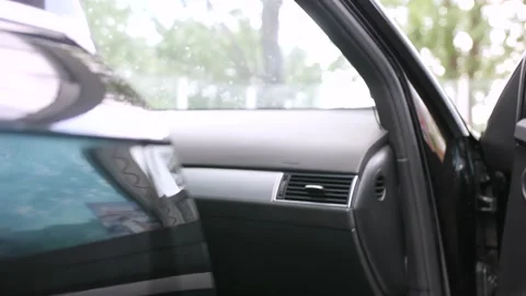 The man is putting front mats into the car interior after the wash Stock Footage 131118870
