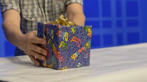 Man putting gift boxes on table Stock Footage 39740711