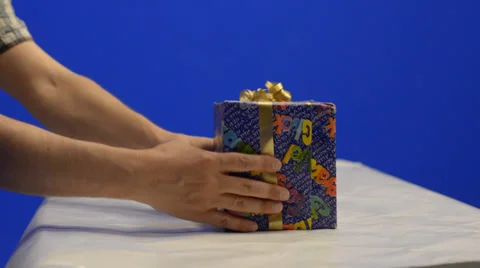Man putting gift boxes on table. Shot from side Stock Footage 39740737