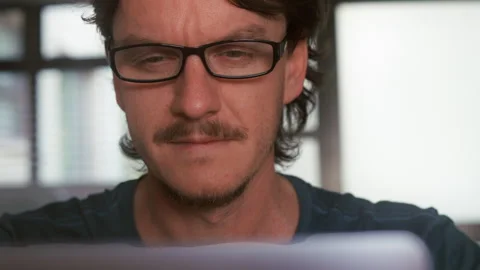Man Putting On Glasses and start to work with Laptop Stock Footage 314403669