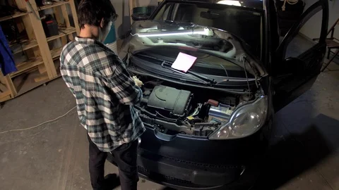 Man putting on gloves in the garage Stock Footage 127436731