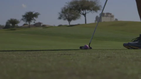 Man Putting Golf Ball, Lips Out of Hole Stock Footage 141079252