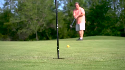 Man putting at golf course green Stock Footage 135664623