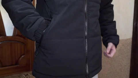 Man putting hands in black jacket pocket Stock Footage 344948268