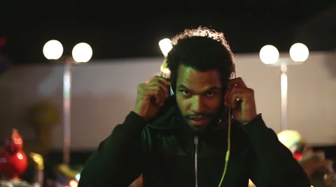 Man putting headphones and dancing to the rhythm of music Stock Footage 59556123