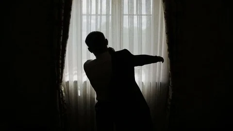 Man putting on a jacket Stock Footage 81681634