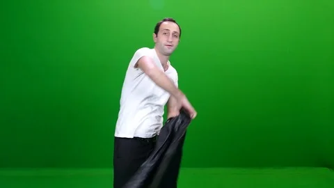 Man Putting on a Leather Jacket on Green Screen Stock Footage 83735155