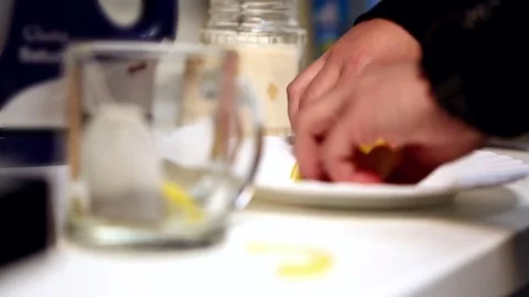 Man putting lemon into a tea cup. Too many lemons Stock Footage 72501350