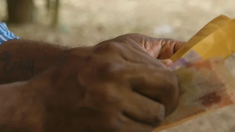 Man putting money in envelope Stock Footage 100076583