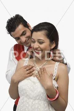 Man putting the necklace in his girlfriend's neck Stock Photos
