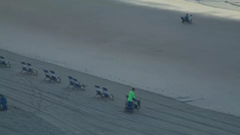Man putting out beach chairs. Stock Footage 341875900